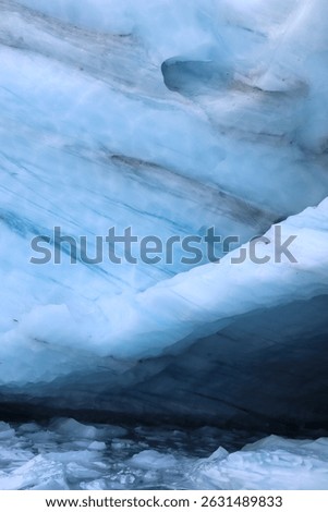 Deep blue ice cave inside Brewster Glacier, Mount Aspiring National Park, New Zealand. A dramatic symbol of climate change, glacial retreat, and natural beauty in the Southern Alps. Background image.