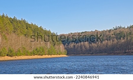 Deep blue lake of Eupen. Artificial lake for drinking water supply. with mixed forest around. Liege, Belgium