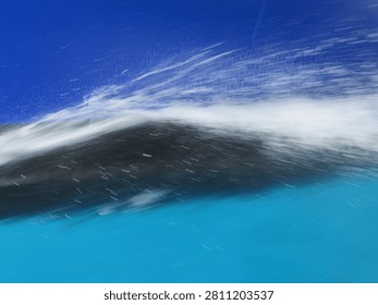 Deep blue ocean wake trailing behind a moving ship on open water