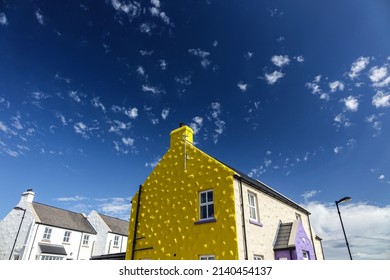 Deep Blue Sky Over Bright Yellow House