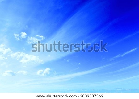 Deep Blue Sky with Wispy Diagonal Clouds