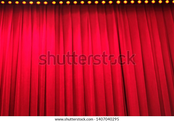 deep bright\
red closed curtain under stage\
light