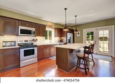 Deep Brown Kitchen Storage Combination And Bar Counter With Two Stools. French Doors Lead To Back Deck. Northwest, USA