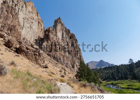Deep canyon view with a sharp bend of the Crooked River beneath towering cliffs at Smith Rock State Park, Oregon, USA