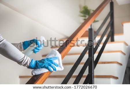 Deep cleaning for Coronavirus disease prevention. alcohol,disinfectant spray on Wipes of Banister in home for safety,infection of Covid-19 virus,contamination,bacteria that are frequently touched