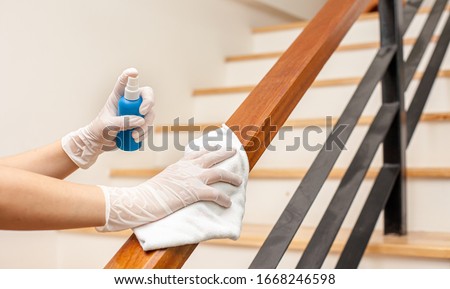 Deep cleaning for Covid-19 disease prevention. alcohol,disinfectant spray on Wipes of Banister in home for safety,infection of Covid-19 virus,contamination,germs,bacteria that are frequently touched . Foto stock © 