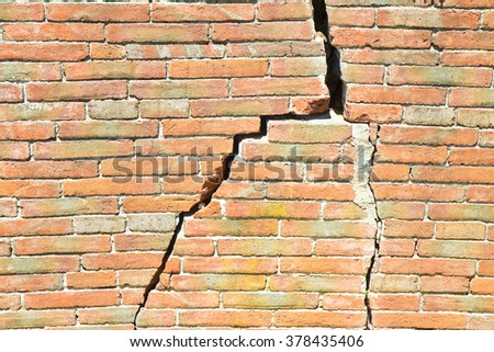 Deep crack in old brick wall - concept image