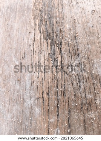 Deep cracked brown wood surface texture with coarse sand grains, rustic timber background
