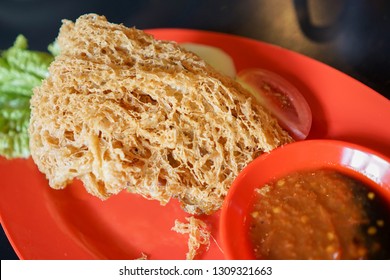 Deep Crispy Fried chicken breaded crisp on a red plate.