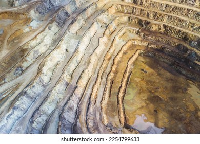 Deep excavation hole of an open pit mine for rare earth elements - Shutterstock ID 2254799633