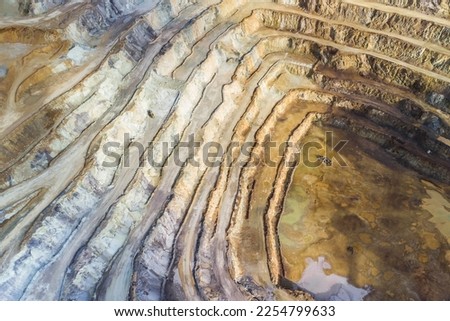 Deep excavation hole of an open pit mine for rare earth elements