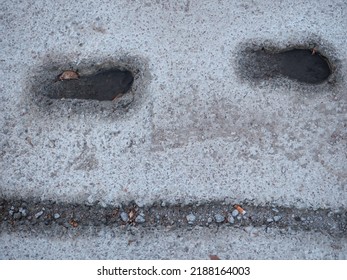 Deep Footsteps And Bike Tire Print Embedded In Wet Cement And Filled With Water After The Rain, And Autumn Leaf Floating In It.