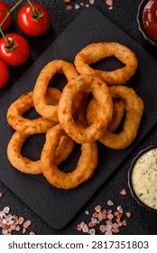 Deep fried breaded onion or squid rings, crispy fast food snacks. Fried onion or squid rings as a food background for your design.