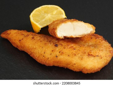 Deep Fried Chicken Tempura On A Slate With Lemon