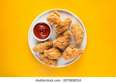 Deep Fried Chicken Wings On Plate Isolated On Yellow Background Top View - Shutterstock ID 2075858314