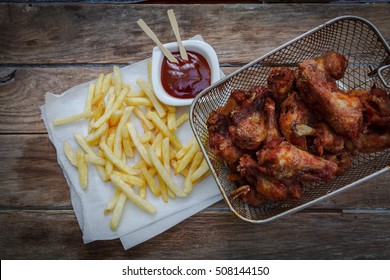 Deep Fried Chicken Wings On Fryer With Bbq Sauce For Dip