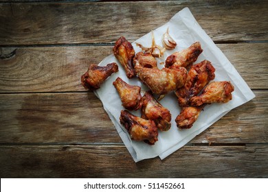 Deep Fried Chicken Wings On Fryer With Garlic