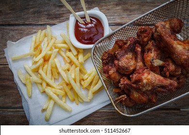 Deep Fried Chicken Wings On Fryer With Bbq Sauce For Dip