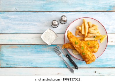 Deep Fried Cod With Chips On A Wooden Table