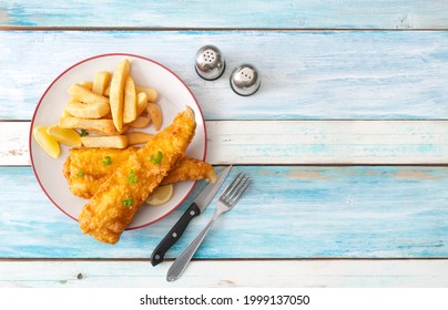 Deep Fried Cod With Chips On A Wooden Table