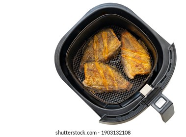 Deep Fried Fish In Tray Of Hot Air Fryer Or Oil-free Fryer, Top View Image, Isolated On White Background. The Concept For Modern And Healthy Cooking. The Fried Fish Is Snakeskin Gourami Fish.