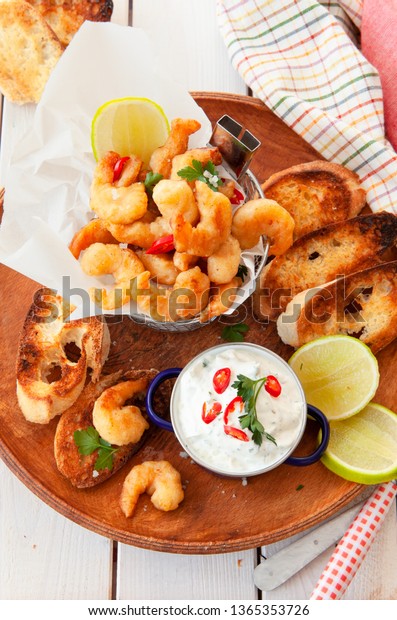 Deep fried popcorn shrimps with garlic dip and\
toasted bread
