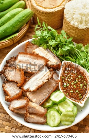 Deep fried pork belly with fish sauce , Fried streaky pork with fish sauce ,thai food ,top view food