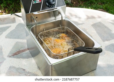 Deep Fried Pork Tonkatsu Stuffed With Cheese In An Electric Fryer.