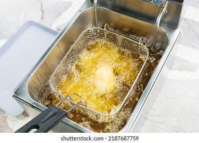 Deep Fried Pork Tonkatsu Stuffed With Cheese In An Electric Fryer.