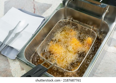 Deep Fried Pork Tonkatsu Stuffed With Cheese In An Electric Fryer.