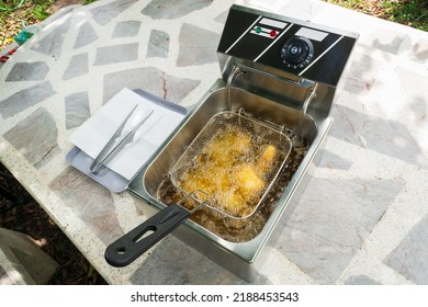 Deep Fried Pork Tonkatsu Stuffed With Cheese In An Electric Fryer.