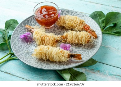 Deep Fried Prawns In Kataifi Dough In A Round Plate.