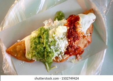 Deep Fried Quesadilla Topped With Cheese And Salsa In Mexico City (Overhead)