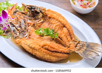 Deep fried seabass fish in black fish sauce