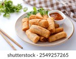 Deep fried vegetable spring rolls or egg rolls and sauce , Thai called popia on white background, vegetarian food