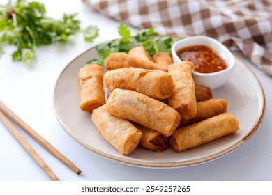 Deep fried vegetable spring rolls or egg rolls and sauce , Thai called popia on white background, vegetarian food