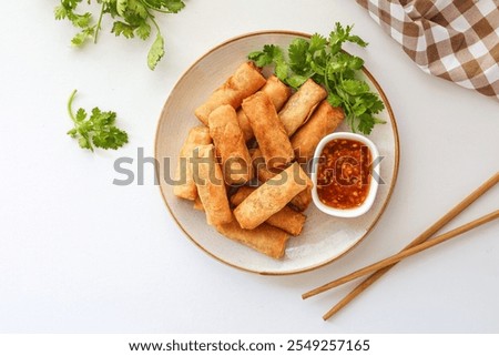 Deep fried vegetable spring rolls or egg rolls and sauce , Thai called popia on white background, vegetarian food