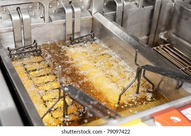 Deep Fryer With Boiling Oil On Restaurant Kitchen