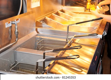 Deep Fryer With Boiling Oil On Restaurant Kitchen