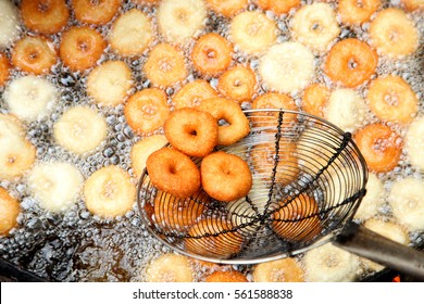 Deep frying medu vada in the pan. Medu Vada is a savoury snack from South India, very common street food in the India.
 - Shutterstock ID 561588838