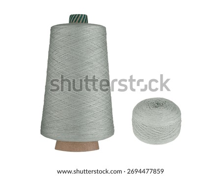 A deep Gray thread set featuring a spool on a cardboard bobbin and two smaller balls, isolated on a white background. Ideal for sewing, knitting, or craft projects, this rich thread adds a bold