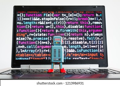 Deep learning concept - robot looking at laptop screen with source code, artificial intelligence, big data concept 
