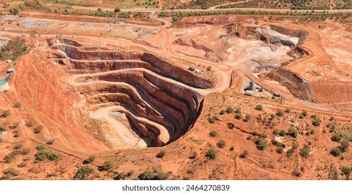 Deep open pit copper ore mine in Cobar town of NSW, Australia - aerial top down view. Stockfotó