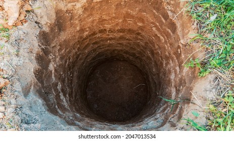 Deep Pit In The Ground. Digging A Hole. Water Well Drilling, Dig A Well For Water, Groundwater Hole Drilling Machine. Big Bottomless Hole In The Ground