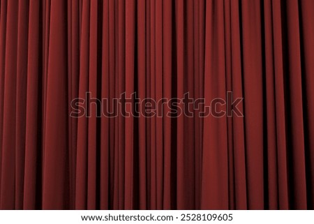 Deep red curtain with many folds background texture
