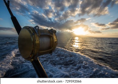 Deep Sea Fishing Reel On A Boat During Sunrise 