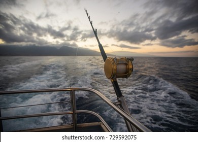 Deep Sea Fishing Reel On A Boat During Sunrise 