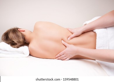 Deep Tissue Massage On The Woman's Middle Back On Erector Spinae Muscles