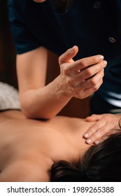 Deep Tissue Massage Therapy. Therapist Massaging Woman’s Back, Using Elbow Pressure.