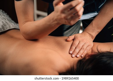 Deep Tissue Massage Therapy. Therapist massaging Woman’s Back, using Elbow Pressure. - Shutterstock ID 1989265400